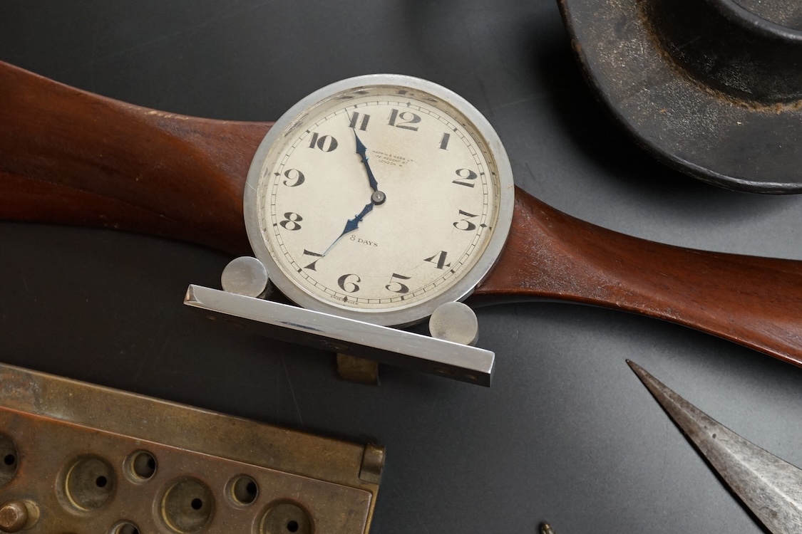 A collection of military equipment, clock, silver commemorative dish etc (6). Propeller mantel clock 41cm wide.